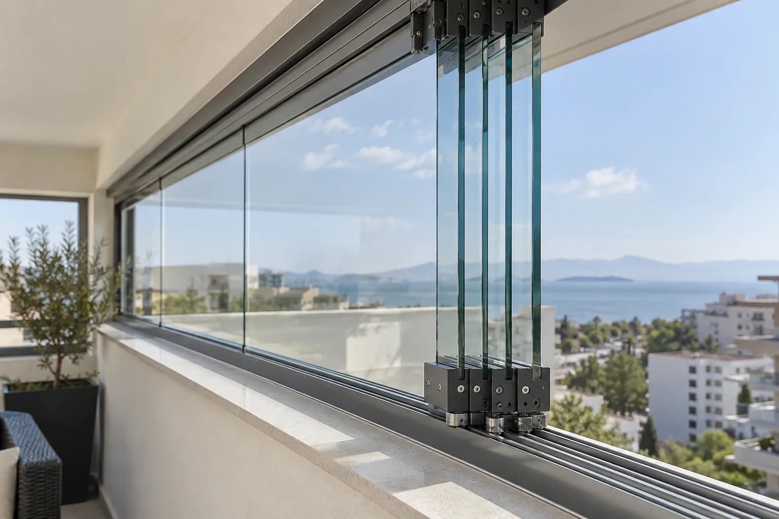 Stacked glass panels and guide-track detail